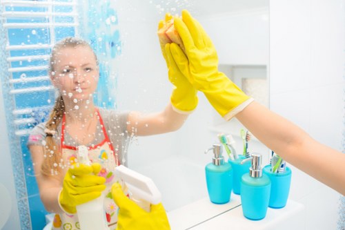 Professional cleaners maintaining a kitchen and washroom in a W3 office